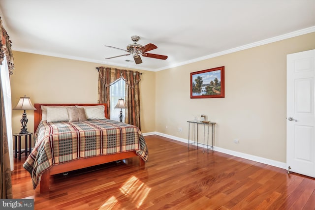 bedroom featuring wood-type flooring, crown molding, and ceiling fan