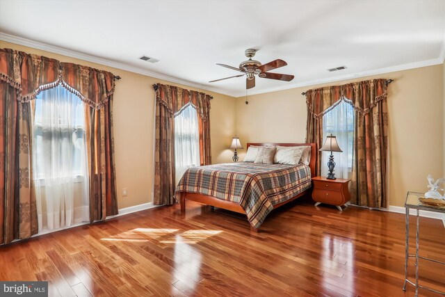 bedroom featuring ornamental molding, hardwood / wood-style flooring, and ceiling fan