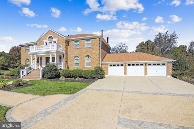 view of front of home featuring a porch, a balcony, and a garage