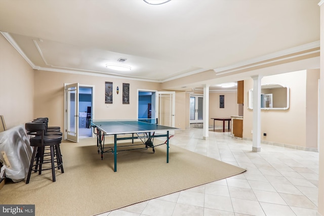 playroom with crown molding and light tile patterned floors