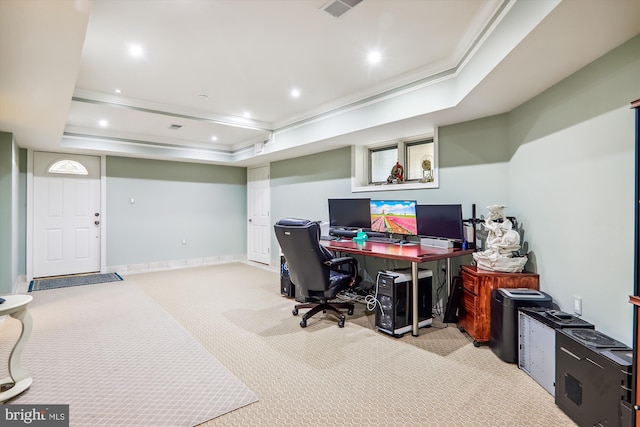 home office with light carpet, a tray ceiling, and crown molding