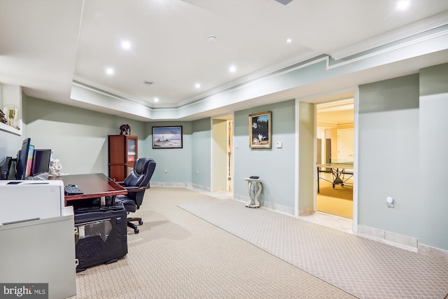 carpeted home office with crown molding and a tray ceiling