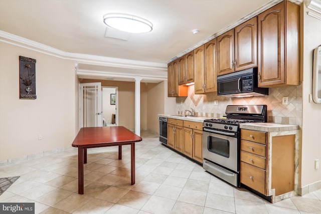 kitchen featuring tasteful backsplash, crown molding, sink, black appliances, and light tile patterned floors