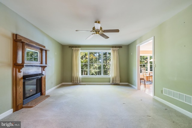 unfurnished living room with light colored carpet and a healthy amount of sunlight