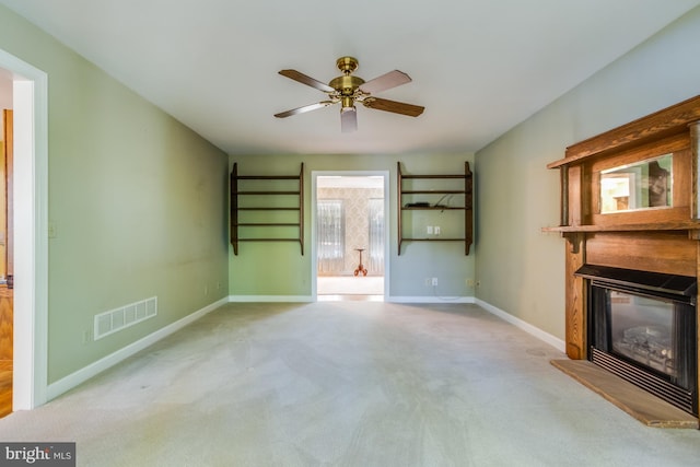 unfurnished living room with light carpet and ceiling fan