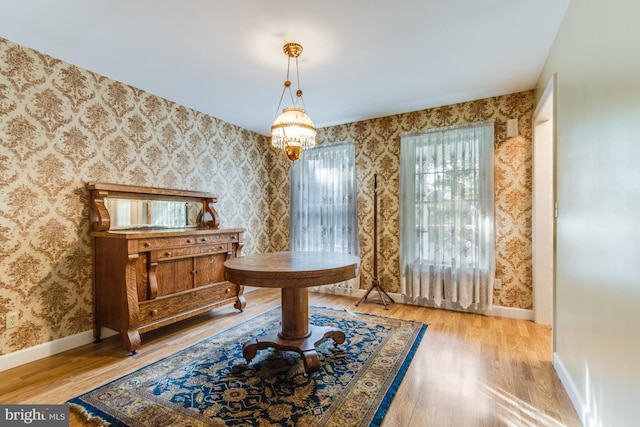 miscellaneous room with a notable chandelier and hardwood / wood-style floors