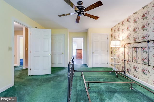 unfurnished bedroom with dark colored carpet and ceiling fan