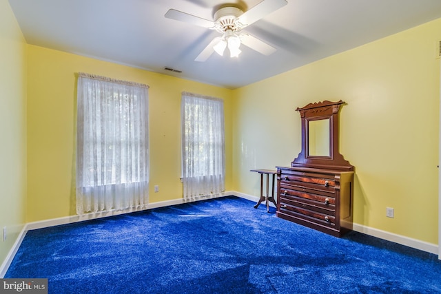 bedroom with dark colored carpet and ceiling fan