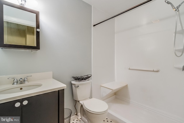 bathroom featuring vanity, toilet, and a shower