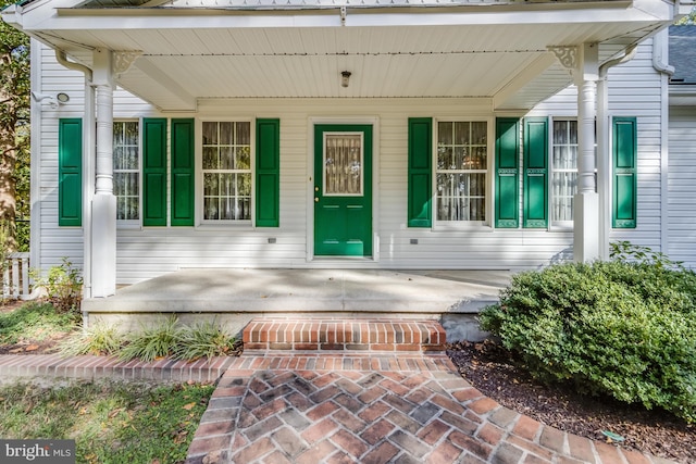 view of exterior entry with covered porch