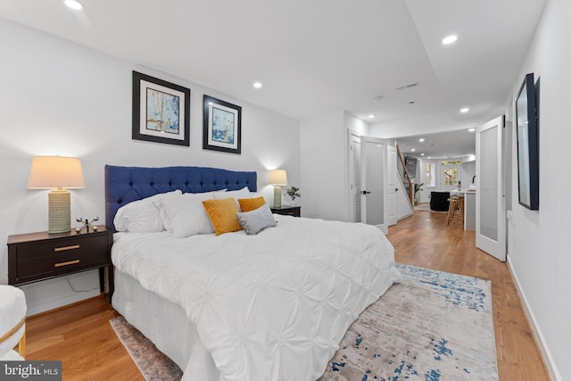 bedroom with light wood-type flooring and a closet