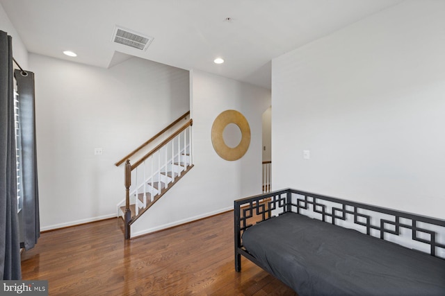 bedroom with dark wood-type flooring