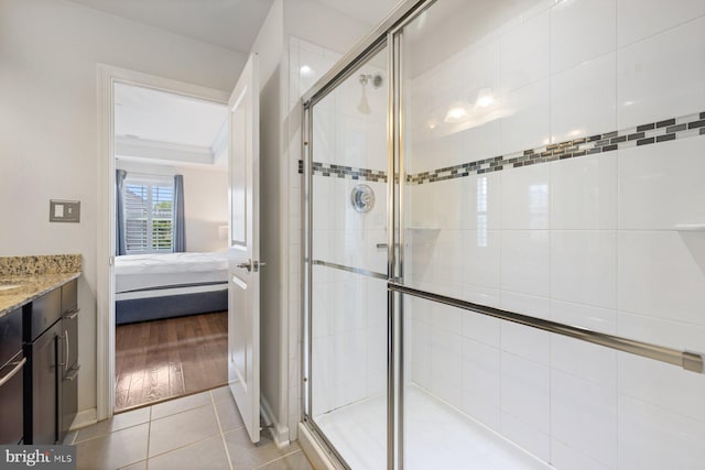 bathroom with an enclosed shower, hardwood / wood-style flooring, and vanity