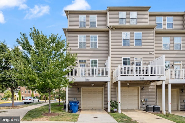 exterior space featuring central AC unit and a garage