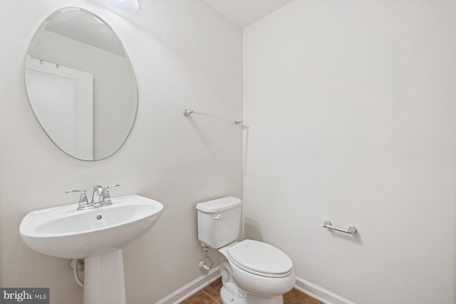 bathroom featuring toilet and tile patterned floors