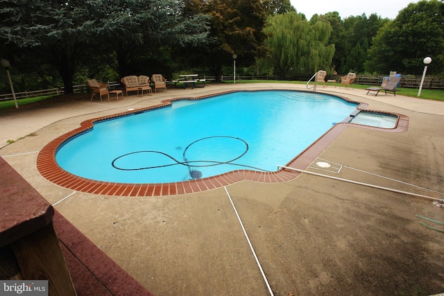 view of swimming pool featuring a patio area