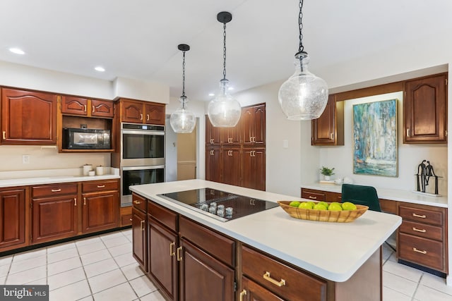 kitchen featuring decorative light fixtures, light tile patterned floors, black appliances, and a center island