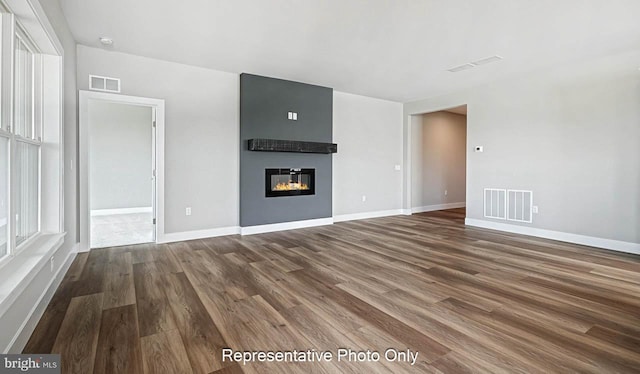 unfurnished living room with a fireplace and hardwood / wood-style flooring