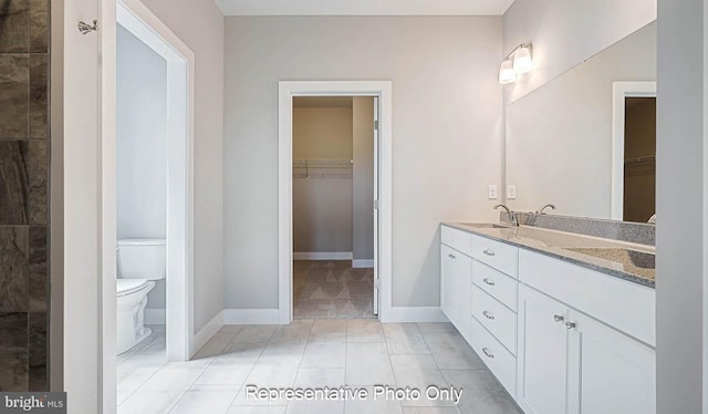 bathroom featuring tile patterned floors, vanity, and toilet