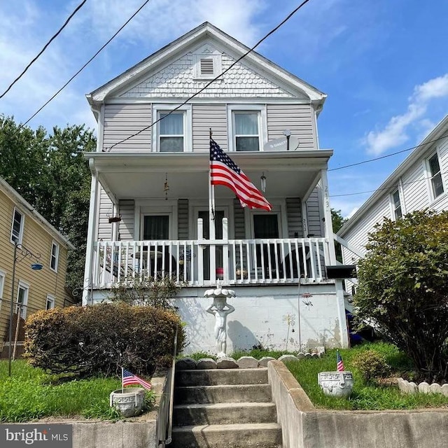 view of property featuring covered porch