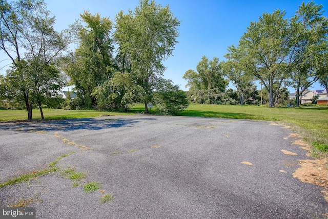 view of car parking with a lawn