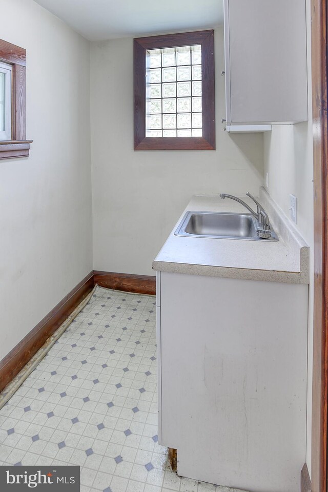 washroom featuring cabinets and sink