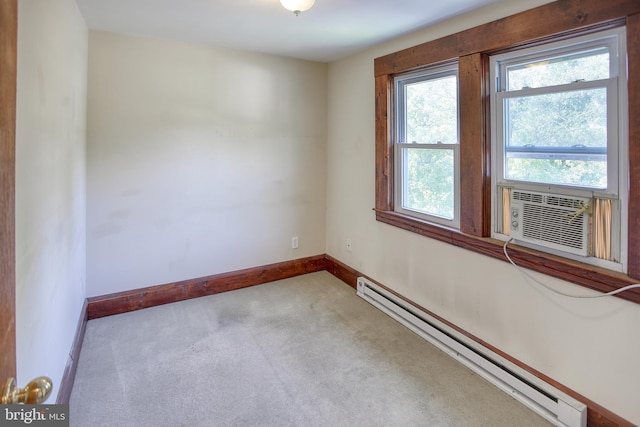 unfurnished room featuring light colored carpet, baseboard heating, cooling unit, and a healthy amount of sunlight