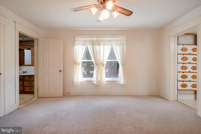 empty room featuring carpet flooring and ceiling fan