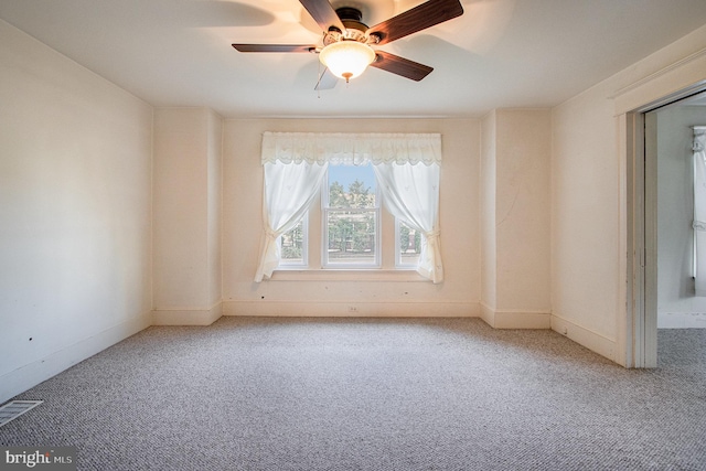 carpeted empty room featuring ceiling fan