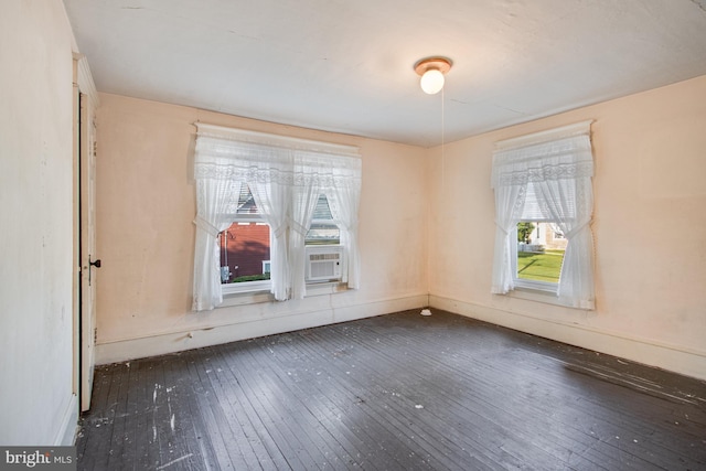 empty room featuring dark hardwood / wood-style flooring and cooling unit