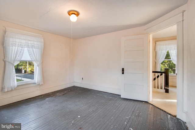 unfurnished room featuring dark hardwood / wood-style floors