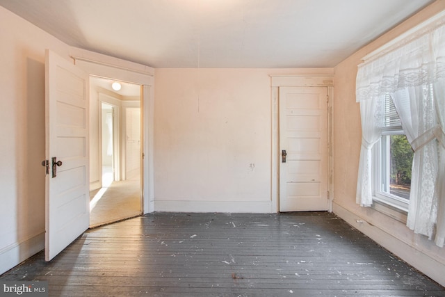 spare room featuring dark wood-type flooring