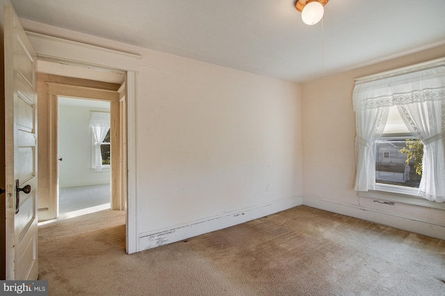 unfurnished room with plenty of natural light and light colored carpet