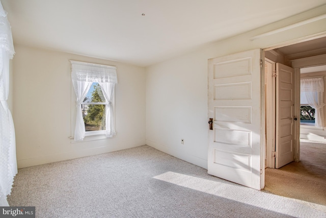 unfurnished bedroom featuring light colored carpet