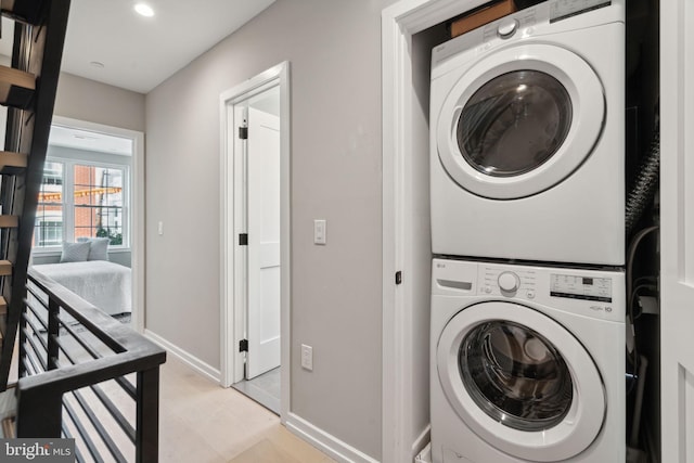 washroom featuring stacked washing maching and dryer