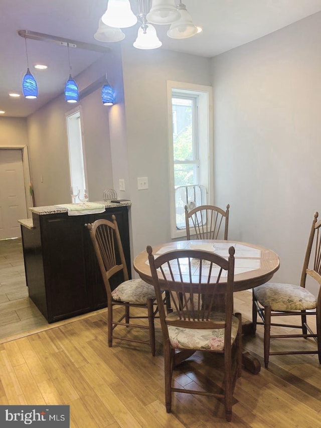 dining area featuring an inviting chandelier and light hardwood / wood-style floors