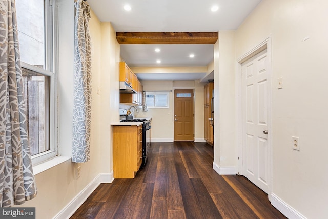 hallway featuring beam ceiling and dark hardwood / wood-style flooring