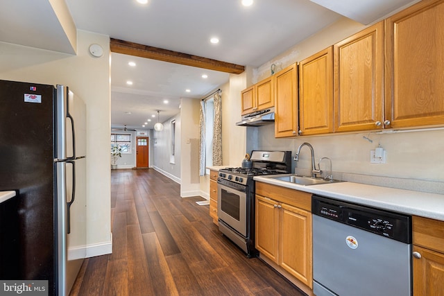 kitchen featuring appliances with stainless steel finishes, dark hardwood / wood-style flooring, beam ceiling, and sink