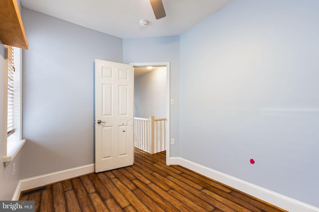 unfurnished room with ceiling fan and wood-type flooring