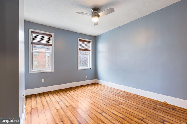 spare room featuring ceiling fan, light hardwood / wood-style floors, and a textured ceiling