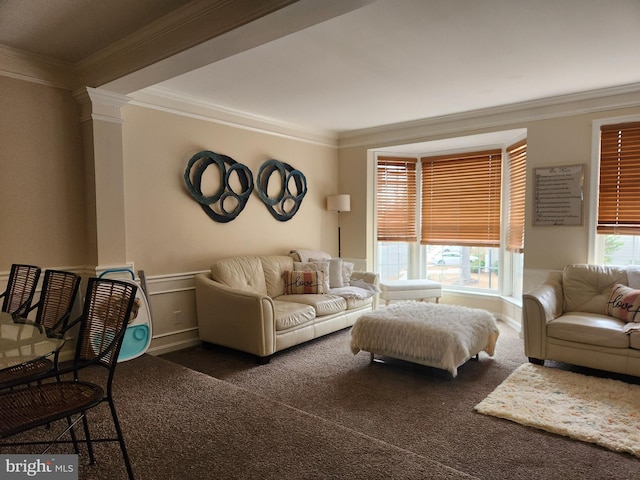 living room featuring ornate columns, crown molding, and dark carpet