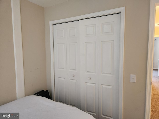 carpeted bedroom featuring a closet