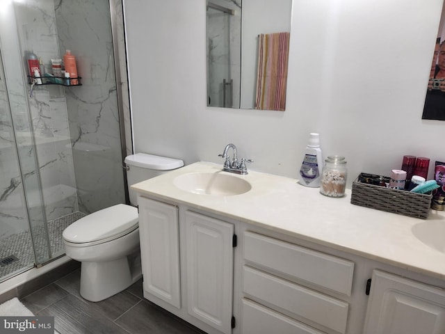 bathroom featuring vanity, toilet, and an enclosed shower