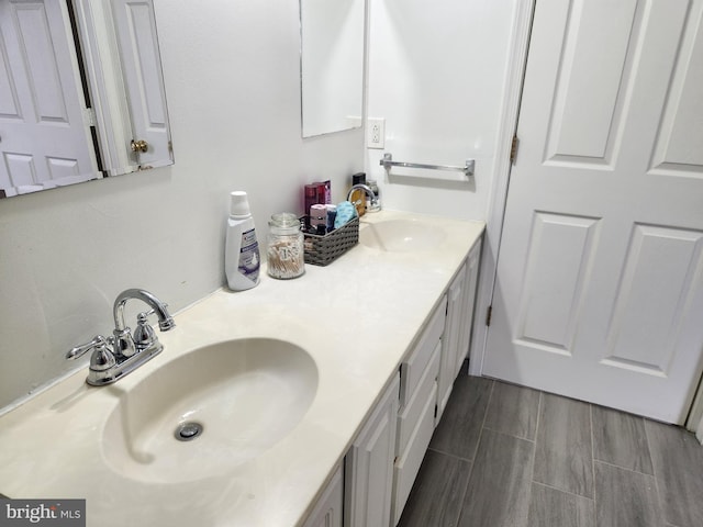 bathroom with vanity and wood-type flooring