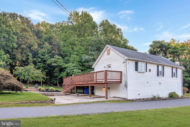 exterior space featuring a front lawn and a deck