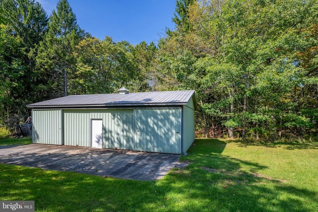 view of outbuilding with a lawn and a garage