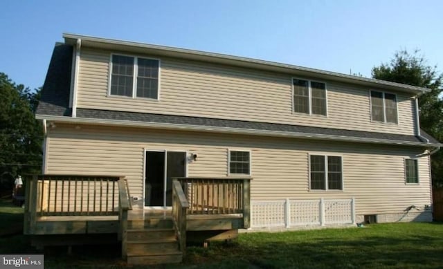 back of house featuring a yard and a wooden deck