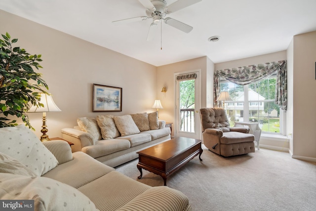 carpeted living room with ceiling fan