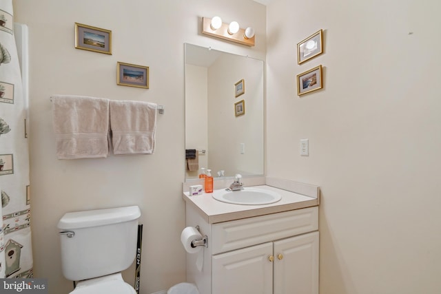 bathroom featuring toilet and vanity