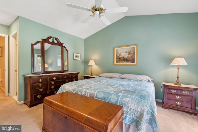 bedroom with lofted ceiling, ceiling fan, and light colored carpet